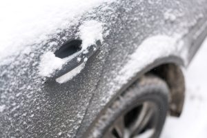 Frozen car under snow